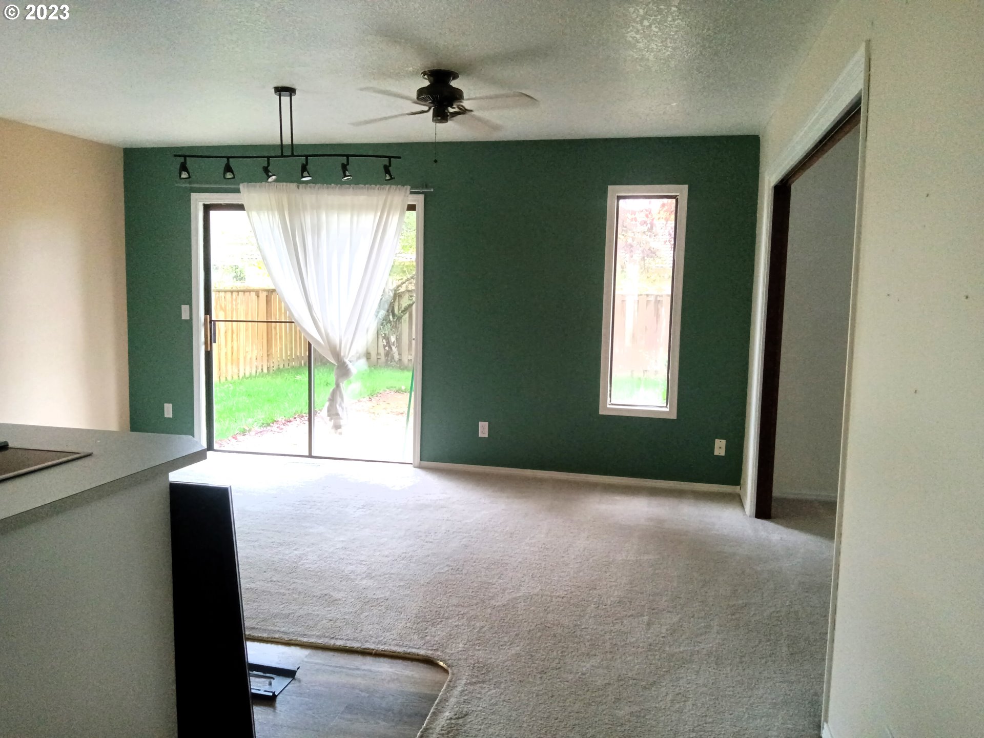 12998 Southwest Gentry Lane Beaverton, OR 97005 - Photo 13 of 22 a view of an empty room with a window and kitchen view