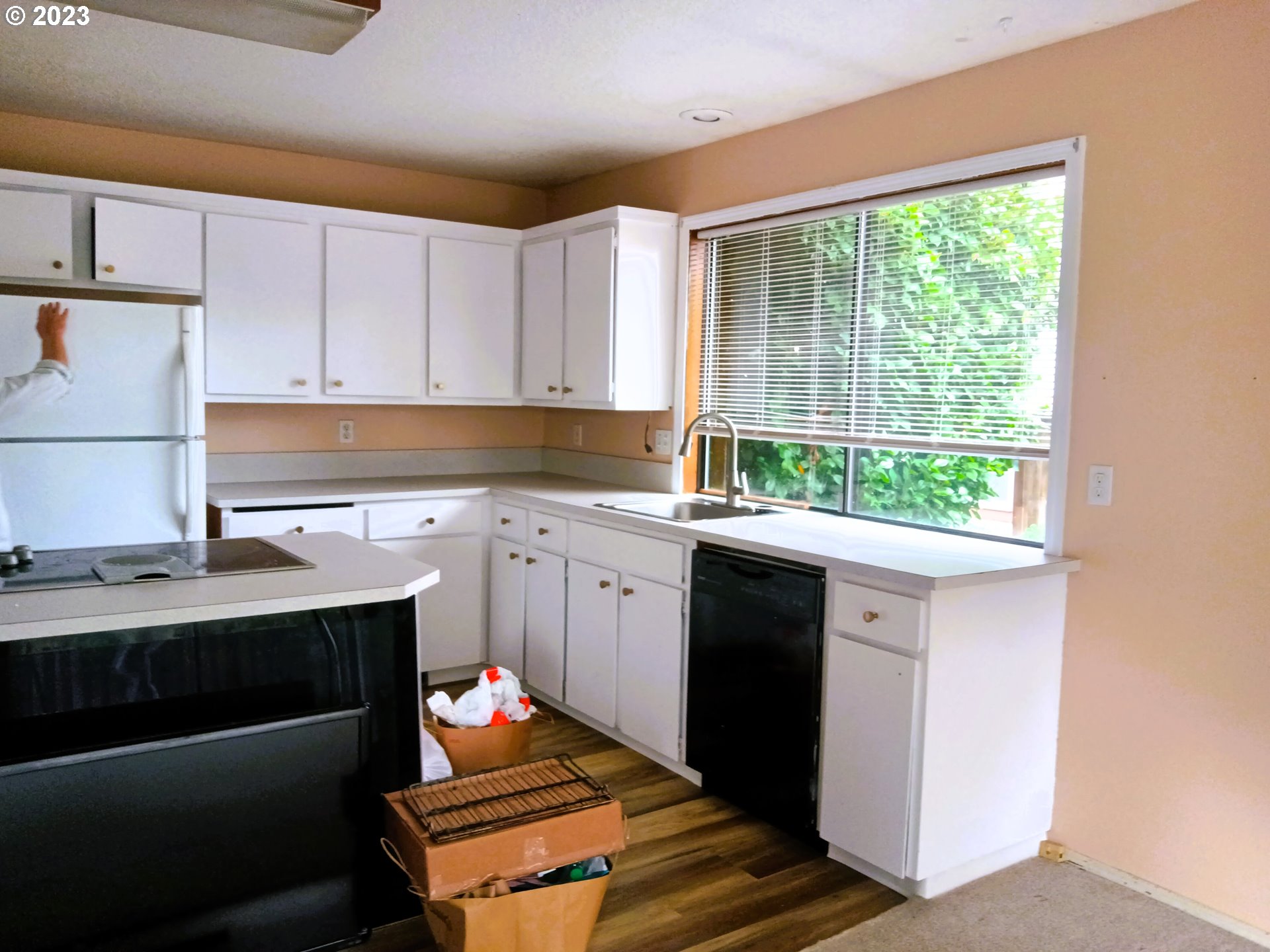 12998 Southwest Gentry Lane Beaverton, OR 97005 - Photo 14 of 22 a kitchen with a sink cabinets and window