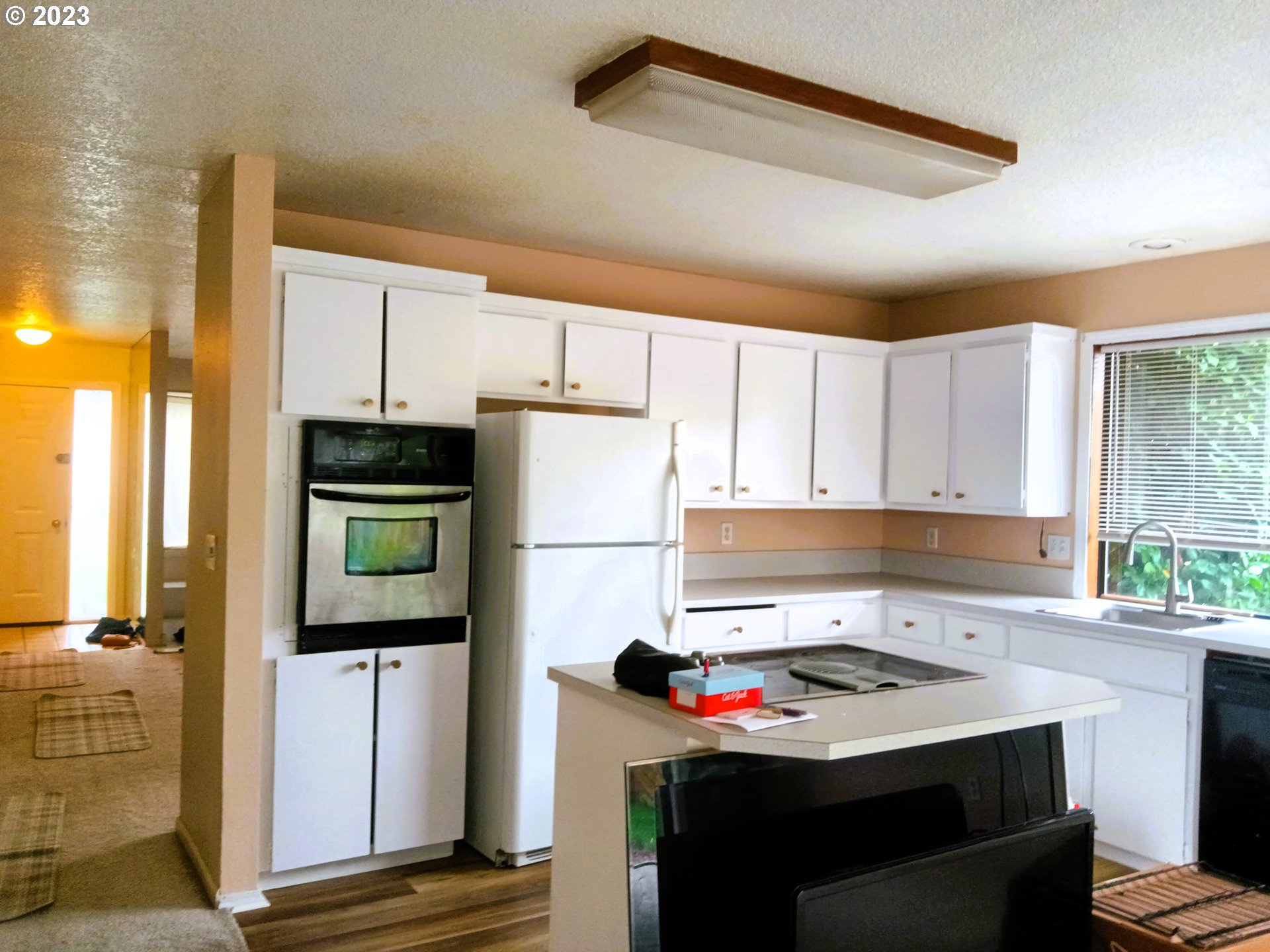 12998 Southwest Gentry Lane Beaverton, OR 97005 - Photo 15 of 22 a kitchen with a stove a refrigerator and a sink