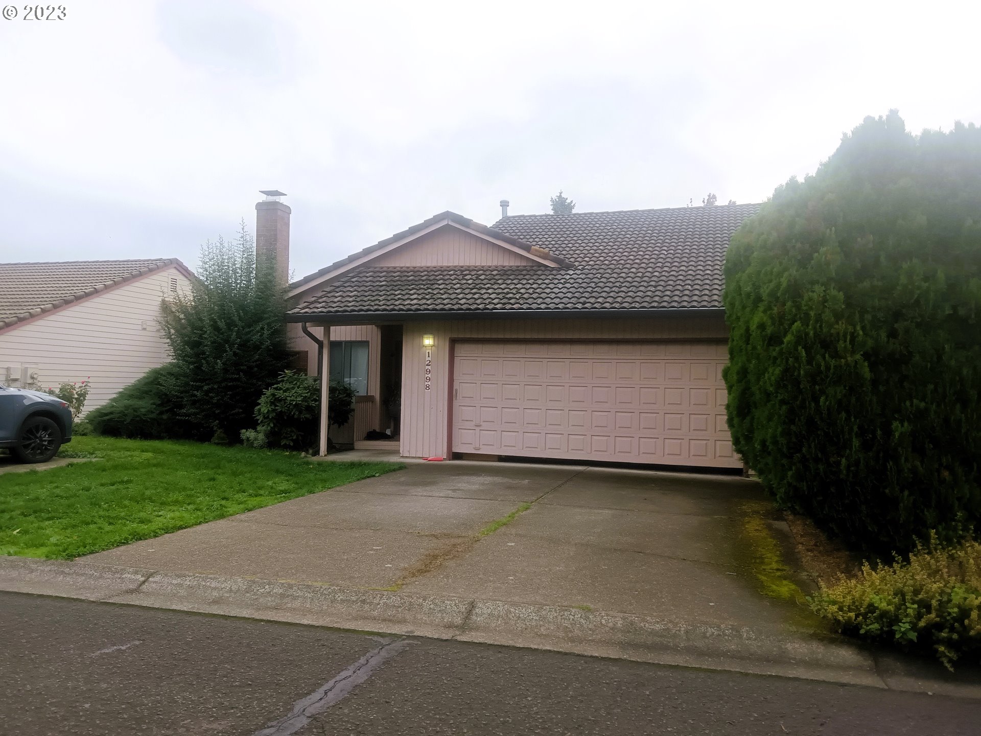 12998 Southwest Gentry Lane Beaverton, OR 97005 - Photo 22 of 22 a front view of a house with garden