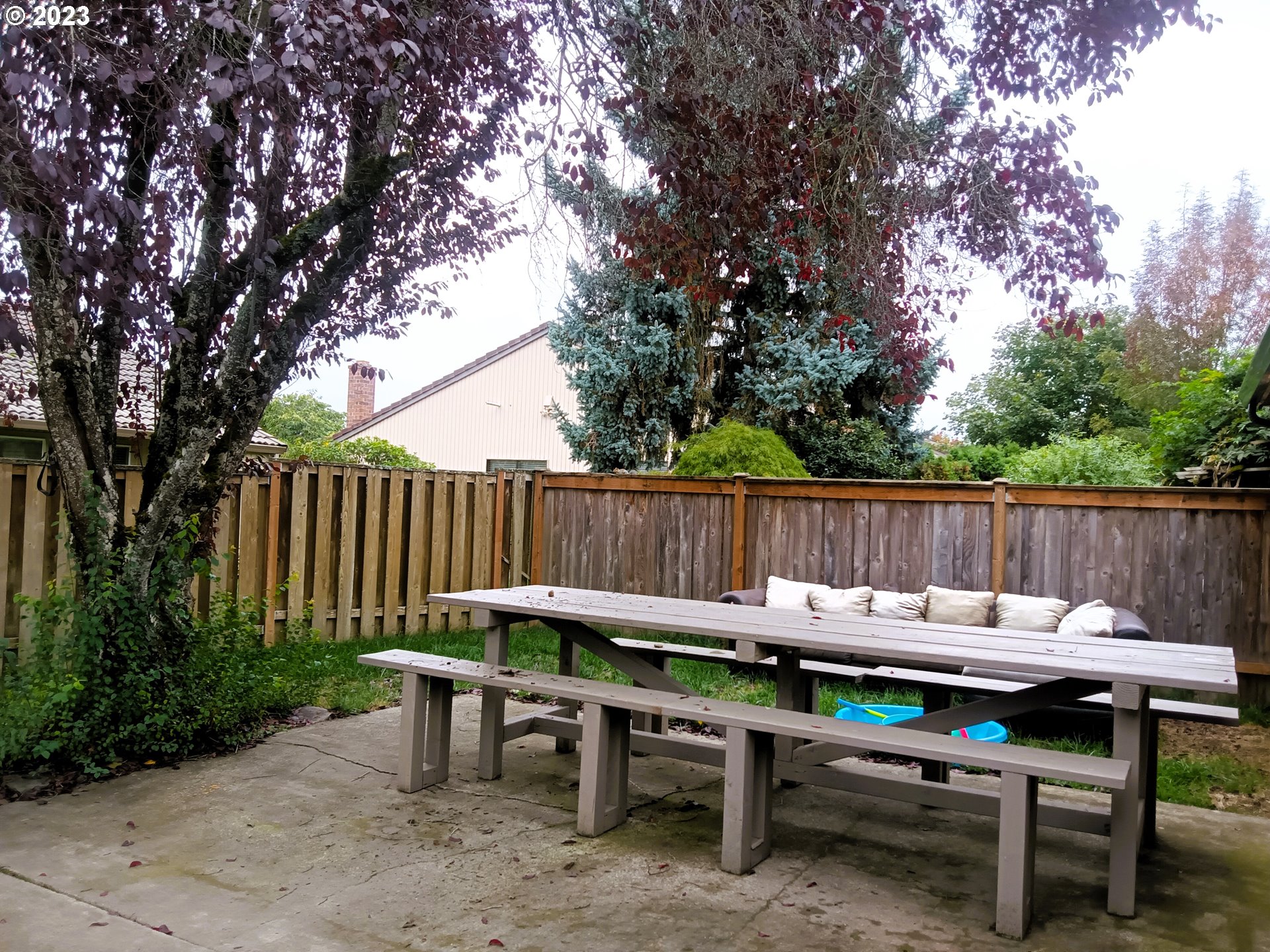 12998 Southwest Gentry Lane Beaverton, OR 97005 - Photo 10 of 22 a view of a wooden chairs and table in the backyard