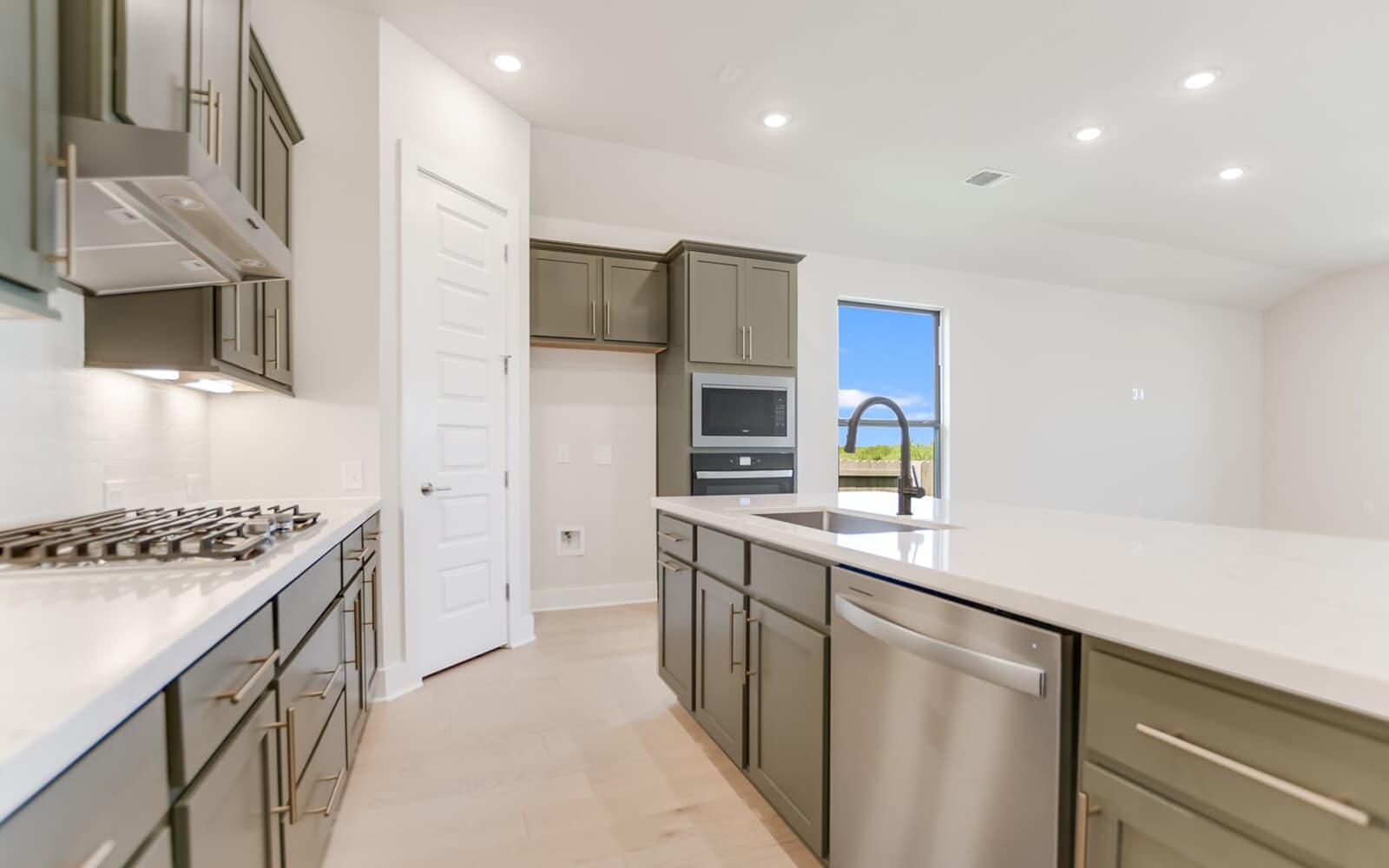 9000 The Ravine Way Austin, TX 78744 - Photo 9 of 17 Kitchen featuring recessed lighting, stainless steel appliances, and light stone counters