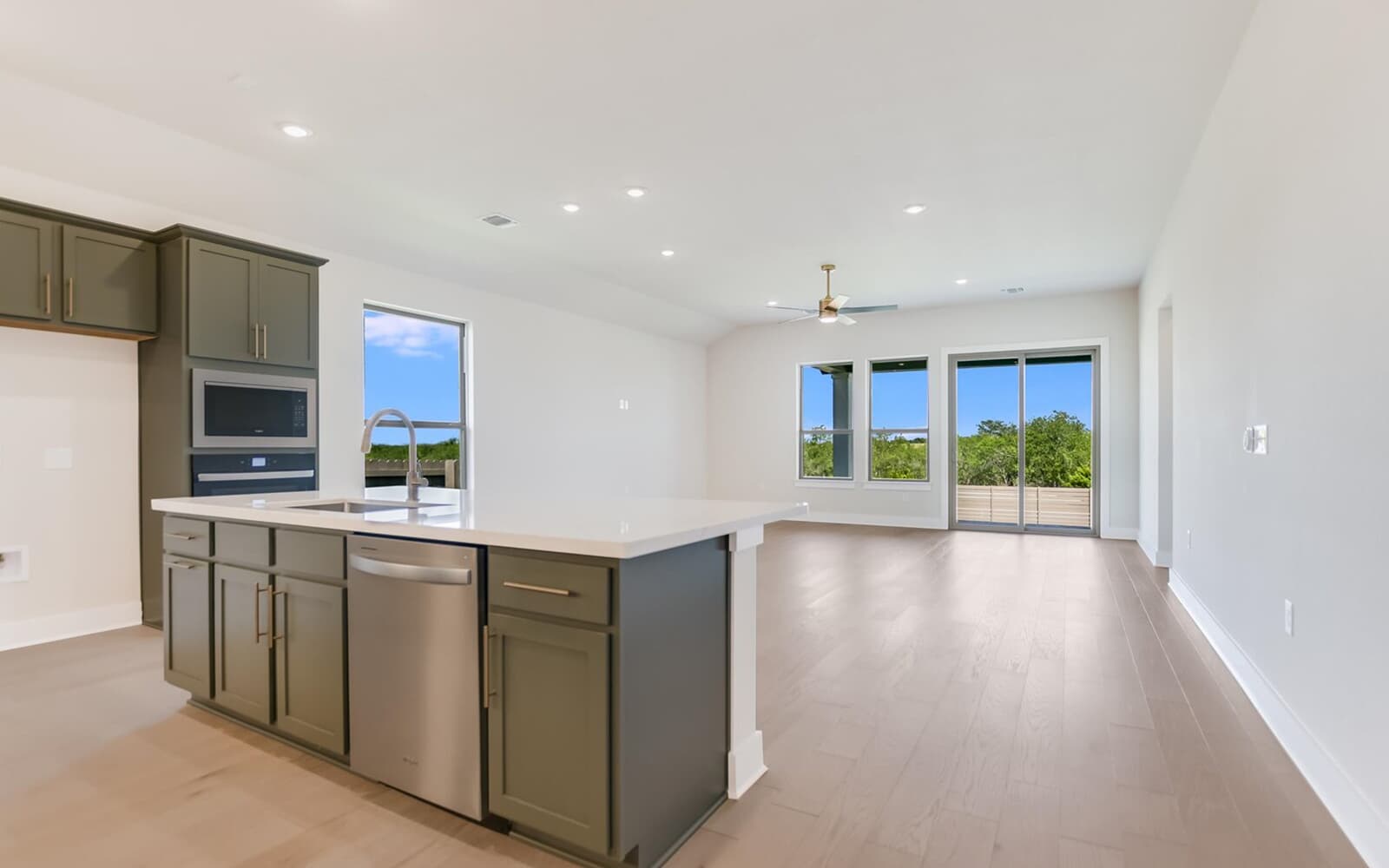 9000 The Ravine Way Austin, TX 78744 - Photo 16 of 17 Kitchen with open floor plan, stainless steel appliances, an island with sink, healthy amount of natural light, and recessed lighting
