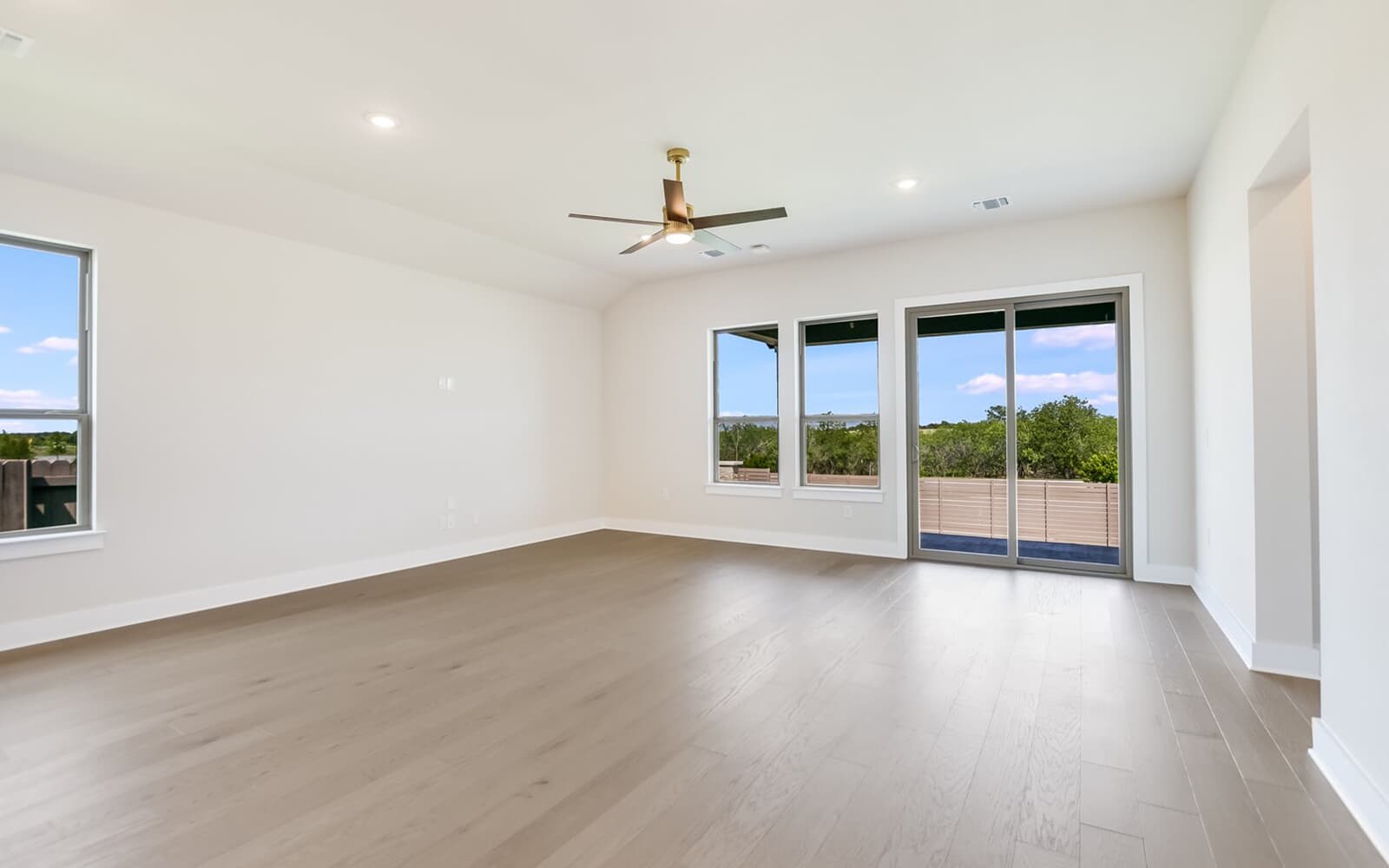 9000 The Ravine Way Austin, TX 78744 - Photo 3 of 17 Spare room with a ceiling fan, light wood-style flooring, and recessed lighting