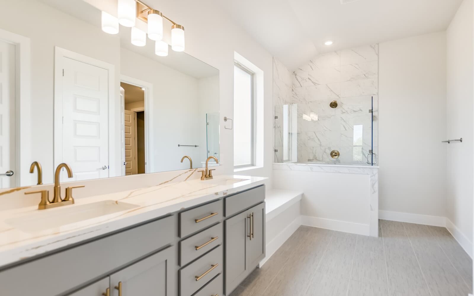 9000 The Ravine Way Austin, TX 78744 - Photo 5 of 17 Bathroom with a marble finish shower, double vanity, and recessed lighting