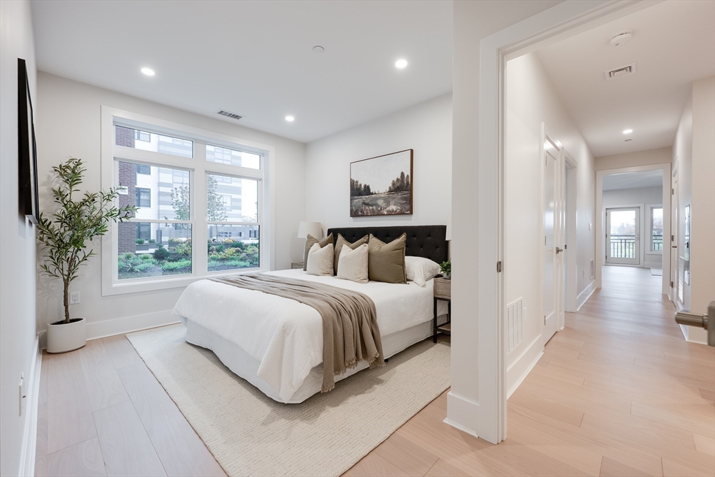 62 Foundry Street, Unit 202 Wakefield, MA 01880 - Photo 12 of 18 a spacious bedroom with a large bed and a large window