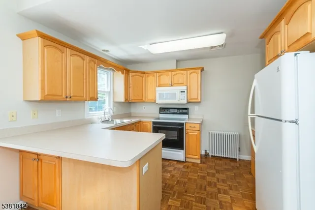 a kitchen with stainless steel appliances a refrigerator sink and stove