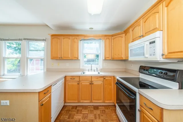 a kitchen with stainless steel appliances granite countertop a sink and a stove
