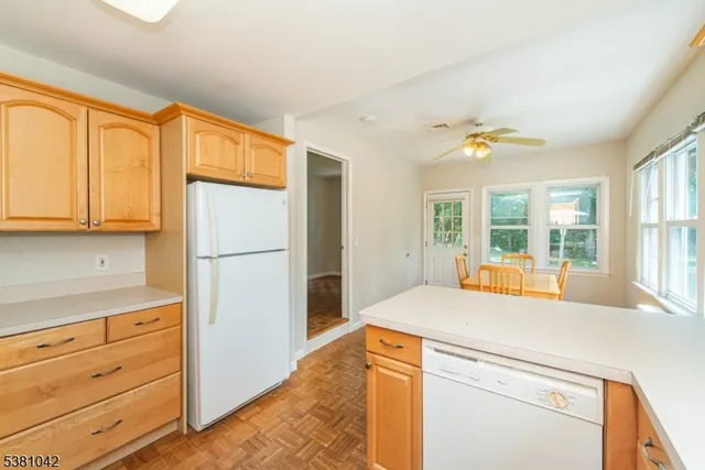 a kitchen with a refrigerator and cabinets