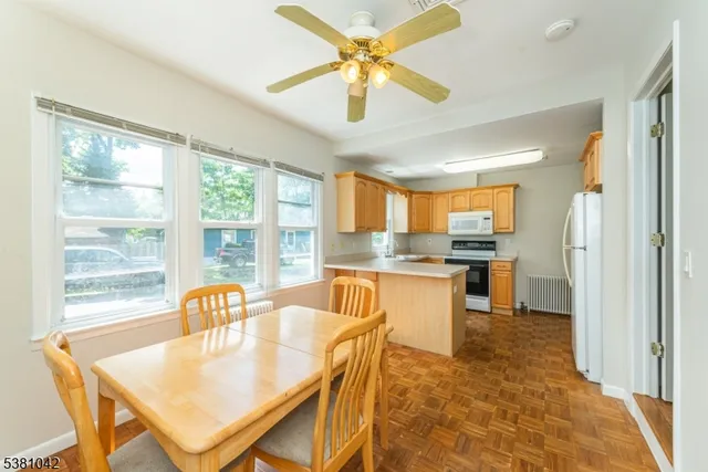 a kitchen with a table chairs refrigerator and cabinets