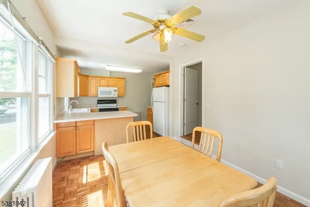 a large white kitchen with a large window