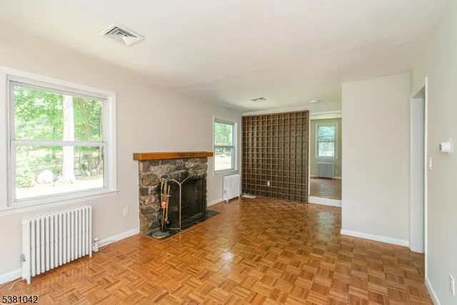 a view of a livingroom with a fireplace and a window