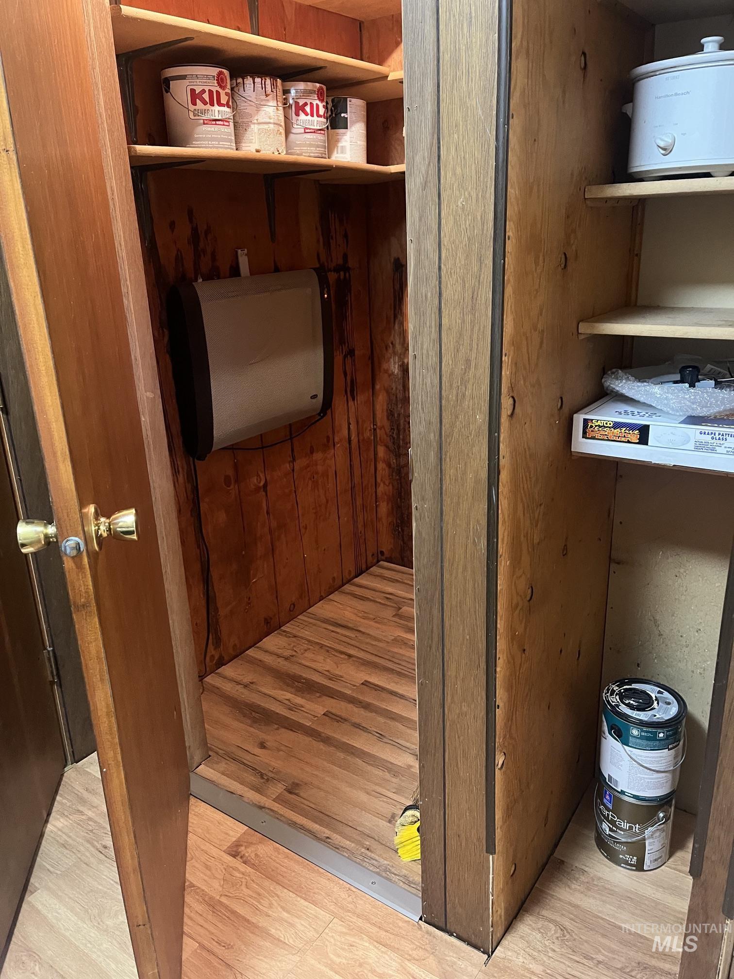 39 Mayflower Mine Road Placerville, ID 83666 - Photo 29 of 36 Utility closet featuring wood-finish flooring and wood-paneled walls