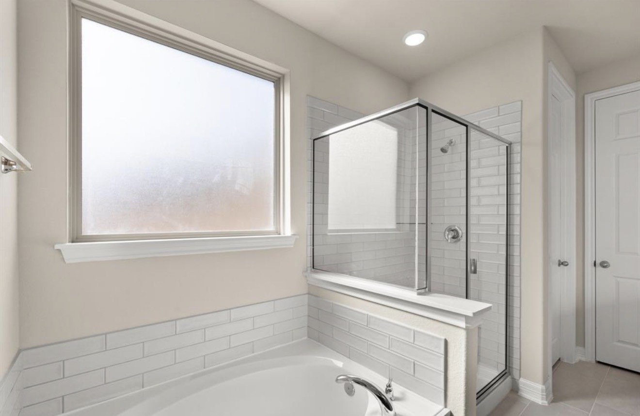 2912 Cliff Ridge Lane Katy, TX 77493 - Photo 13 of 36 a bathroom with a bathtub and a shower