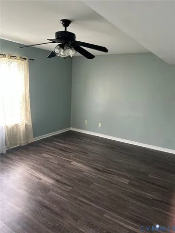 a view of a room with wooden floor and windows