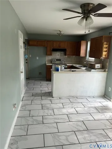 a kitchen with stainless steel appliances granite countertop a sink and a stove