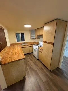a kitchen with stainless steel appliances granite countertop a refrigerator a stove and a microwave