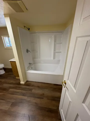 a bathroom with a tub and shower