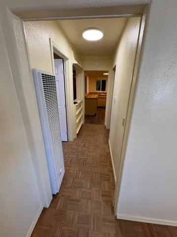 a view of hallway with furniture and stairs