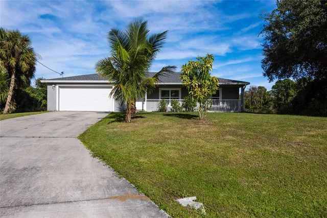 a front view of house with yard and trees