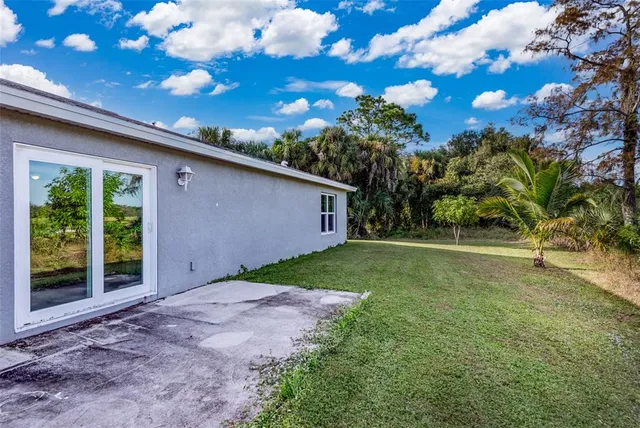 a backyard of a house with lots of green space