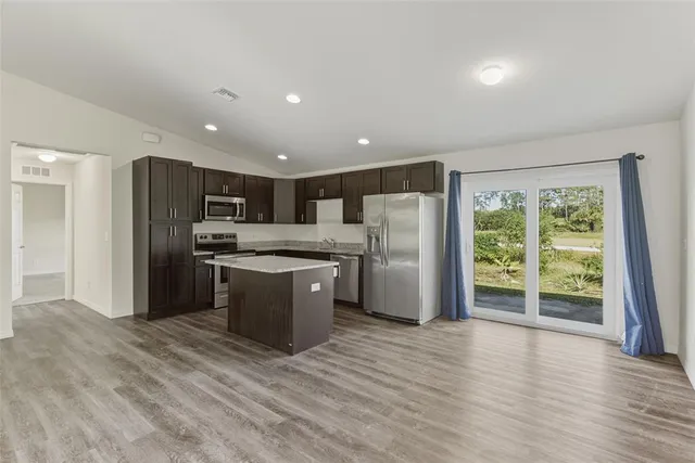 a kitchen with stainless steel appliances a refrigerator and a sink
