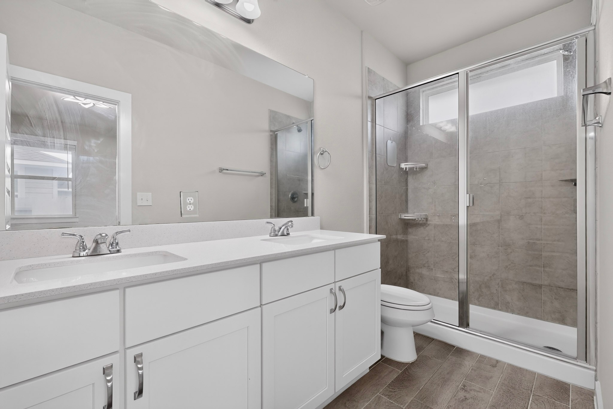 116 Appleberry Lane Elgin, TX 78621 - Photo 16 of 35 A well-appointed primary bathroom showcases a dual vanity with ample counter space and a sleek walk-in shower.