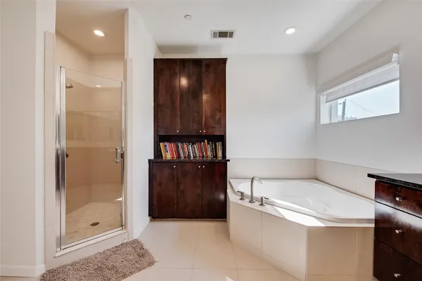 a bathroom with a tub shower and sink