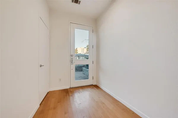 a view of an empty room and wooden floor