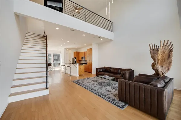 a living room with furniture and wooden floor