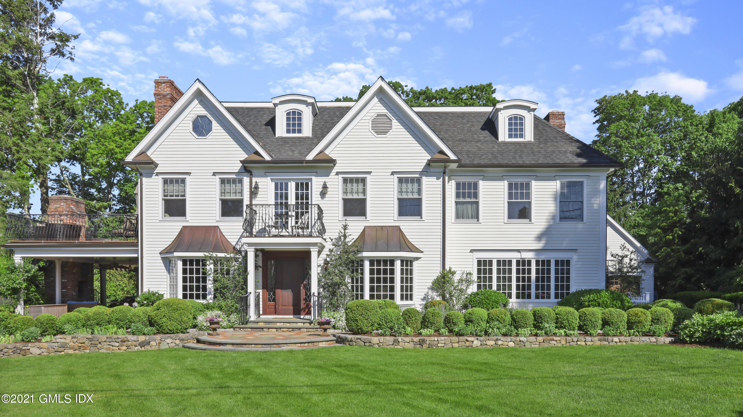 74 Cedar Cliff Road Riverside, CT 06878 - Photo 1 of 66 a front view of a house with a yard and trees