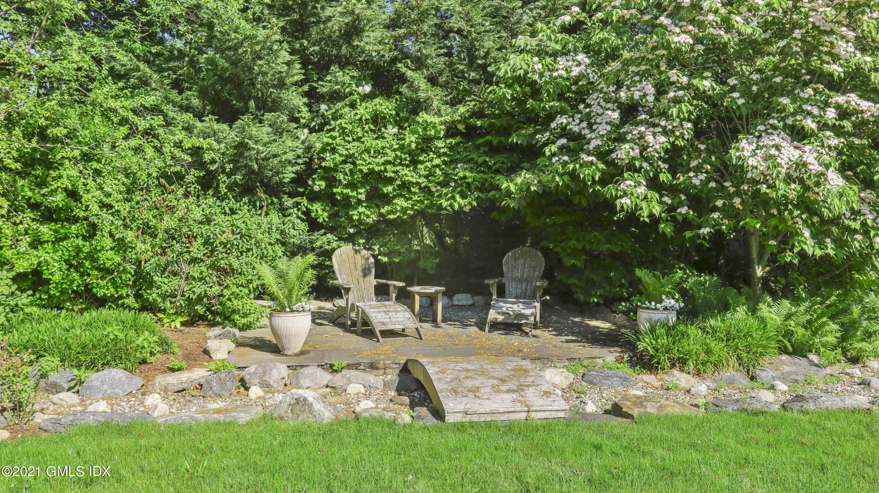 74 Cedar Cliff Road Riverside, CT 06878 - Photo 54 of 66 a view of backyard with a table and chairs and a large tree