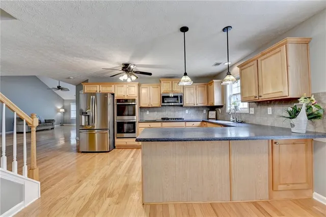a view of room with window ceiling fan and wooden floor