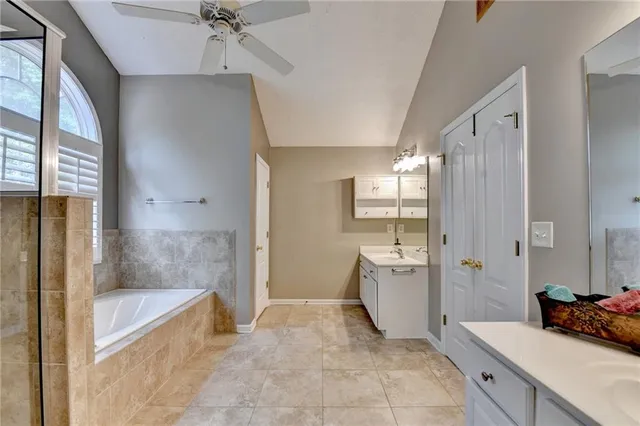 a view of a livingroom with a ceiling fan and window