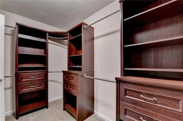 an empty room with closet and windows