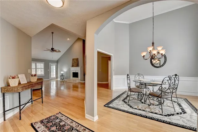 a view of a dining room with furniture and chandelier