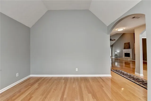 a living room with furniture a fireplace and a ceiling fan