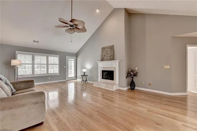 a view of empty room with wooden floor and window