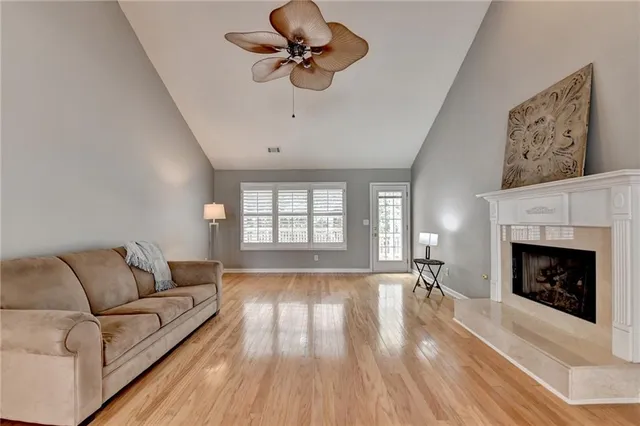 a large kitchen with granite countertop a stove and a wooden floor