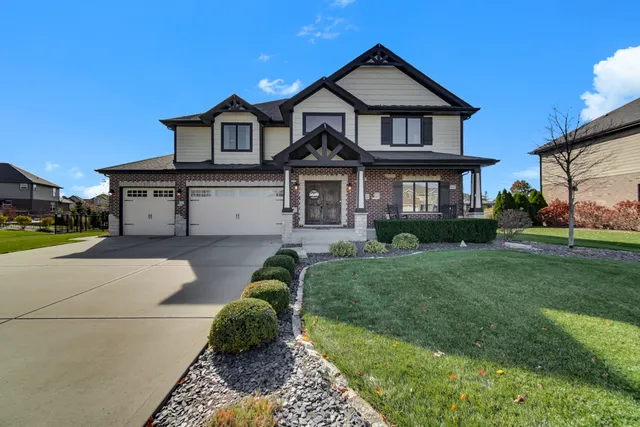 a front view of a house with a yard and garage