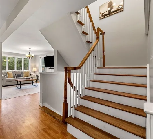 a view of entryway and hall with wooden floor