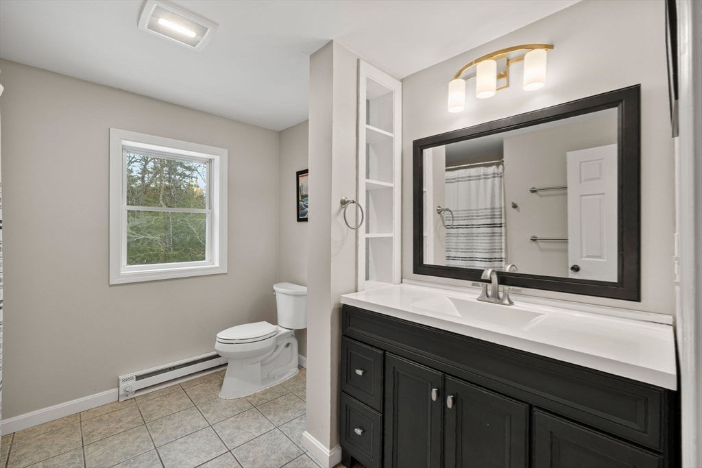 101 Rogers Road Center Barnstead, NH 03225 - Photo 15 of 32 a bathroom with a double vanity sink toilet and a mirror