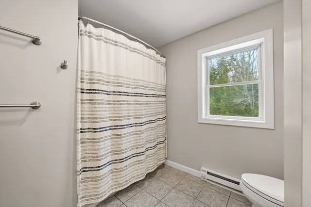 a bathroom with a window and a shower