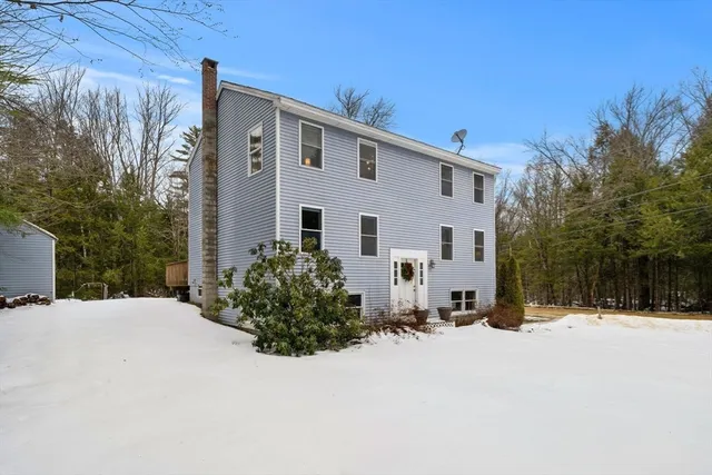 a view of a white house with a yard