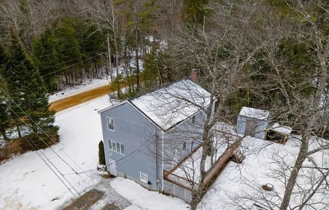 a view of a house with a yard and sitting area