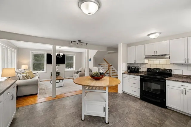 a kitchen with stainless steel appliances kitchen island granite countertop a sink and cabinets