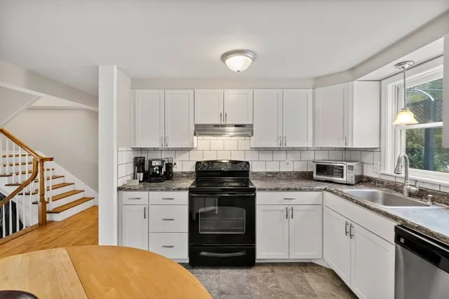 a kitchen with a stove a sink and a microwave