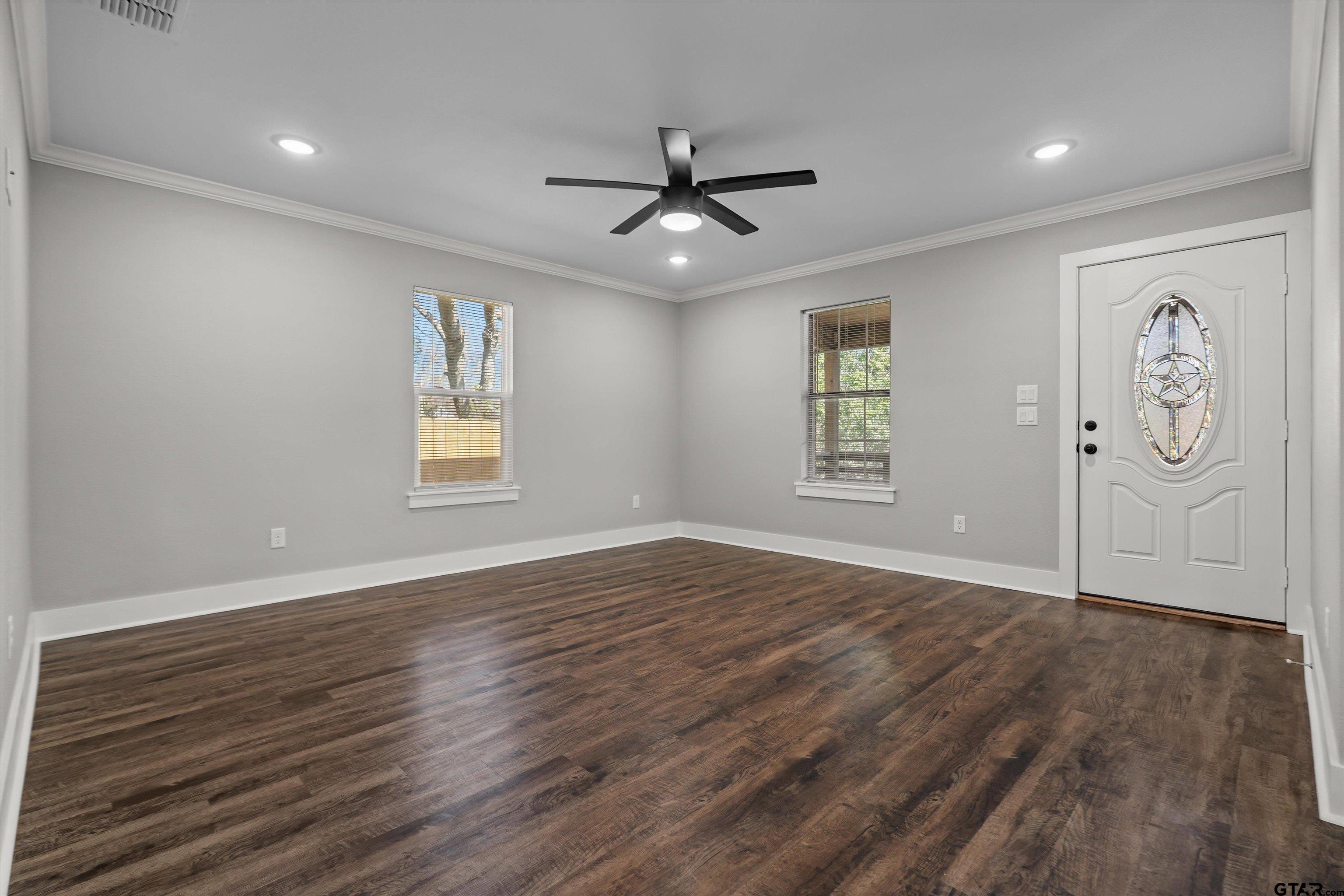 5881 Jefferson Avenue Tyler, TX 75708 - Photo 11 of 20 wooden floor in an empty room with a window