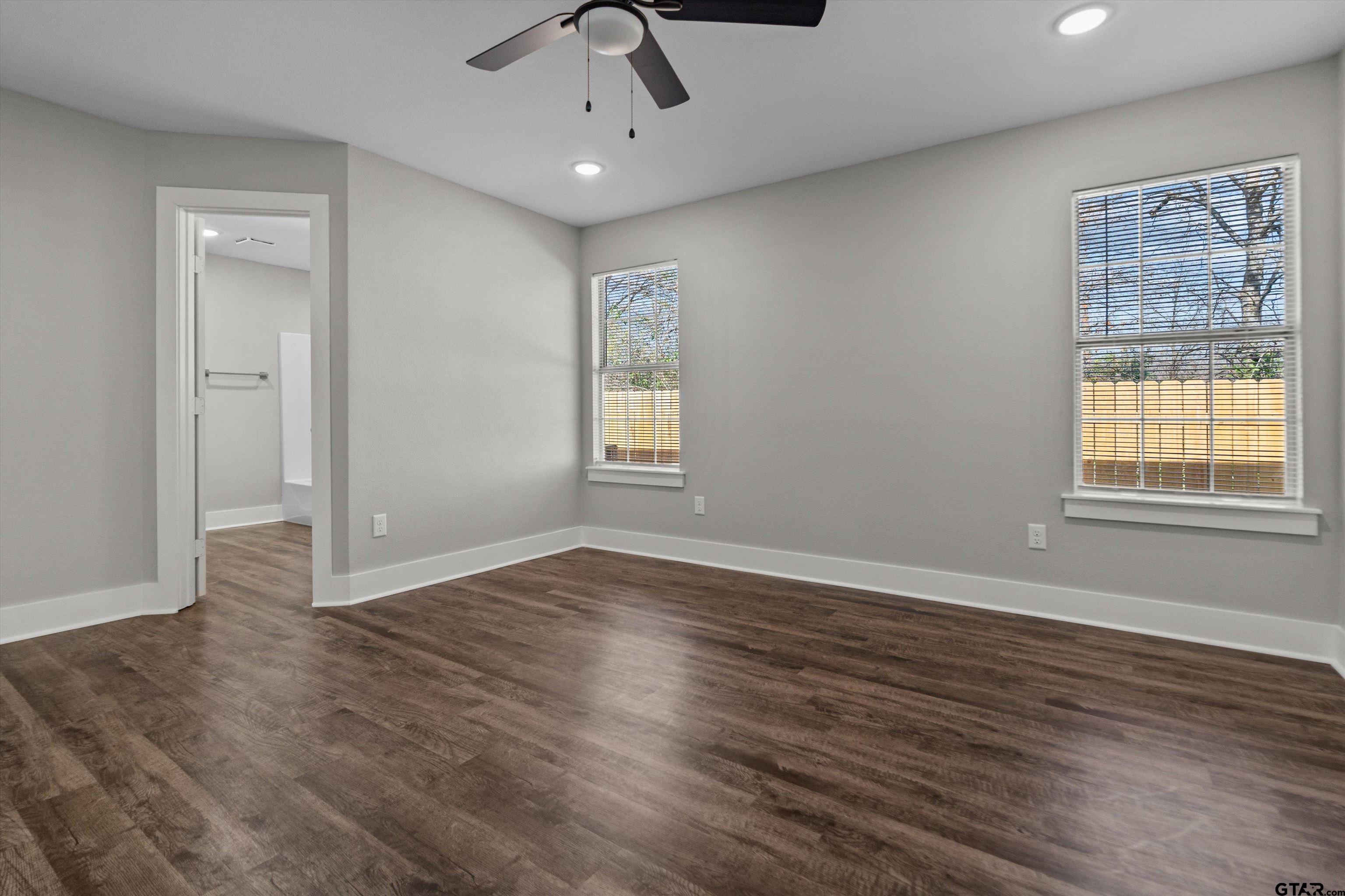 5881 Jefferson Avenue Tyler, TX 75708 - Photo 12 of 20 a view of an empty room with wooden floor and a window