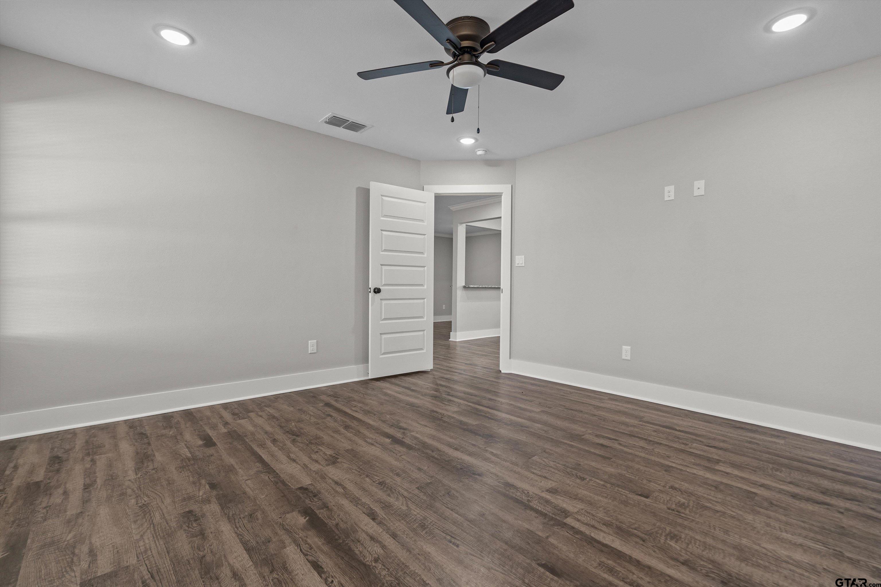 5881 Jefferson Avenue Tyler, TX 75708 - Photo 13 of 20 a view of an empty room with wooden floor